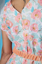 Floral dress with apricot and turquoise flowers on a blue background