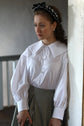 48-6 Blouse with an oversized collar and pearl buttons